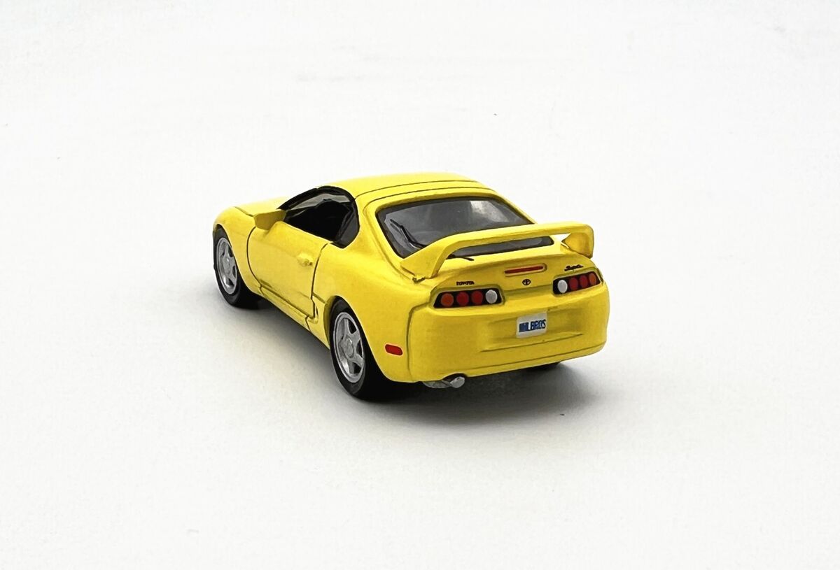 Toyota Supra 1996 galbena - 1/64 AutoWorld